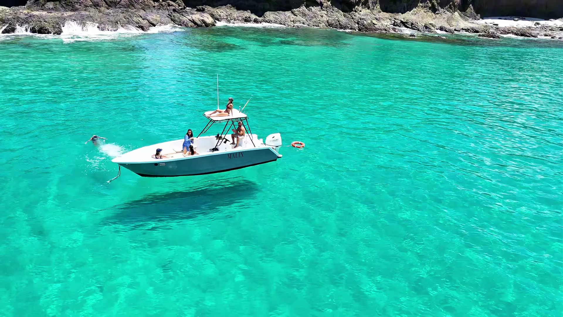 The Malix boat anchored in a hidden turquoise cove off Playa Flamingo